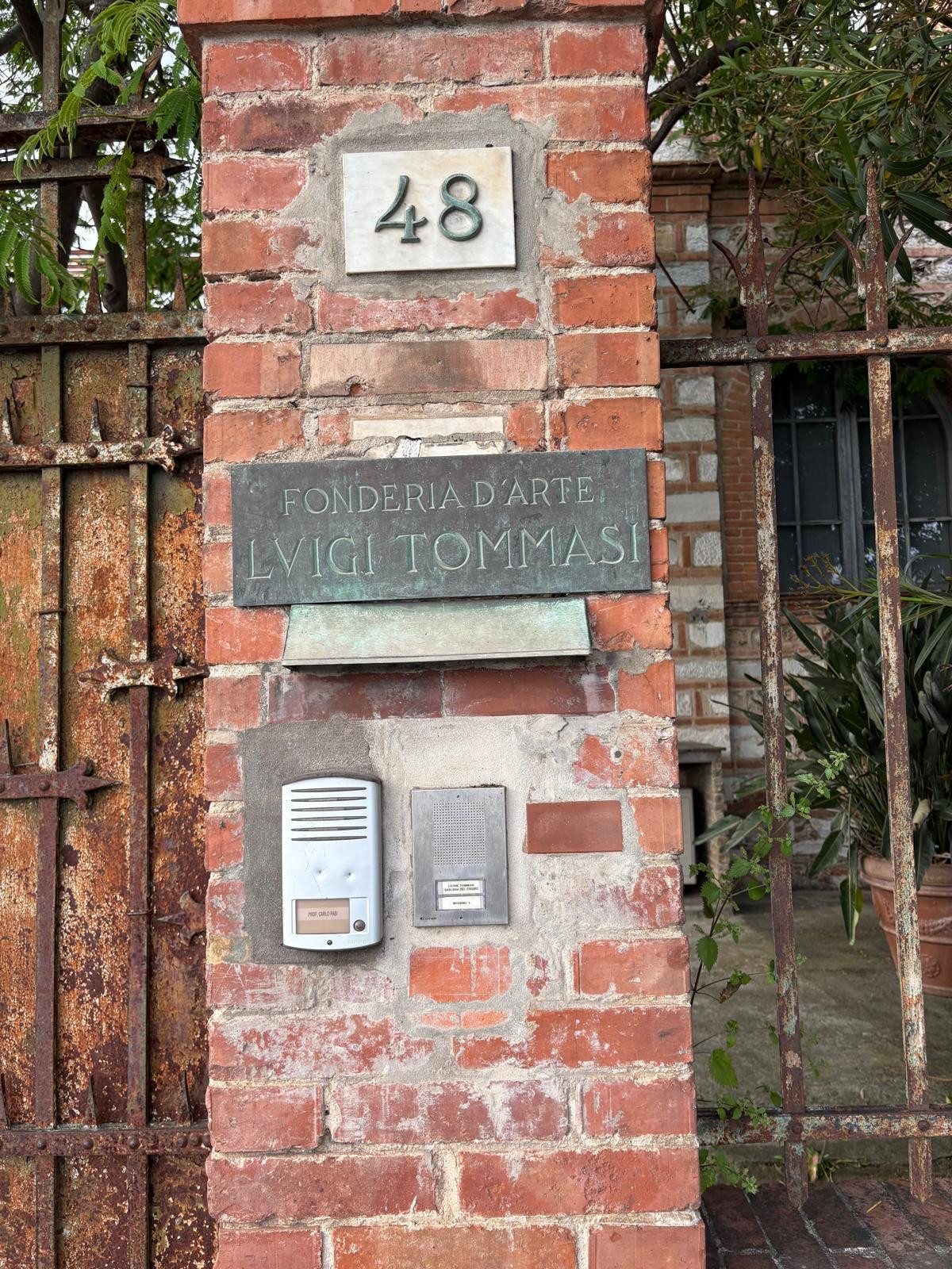 Buzzer on red brick pillar entrance to art studio