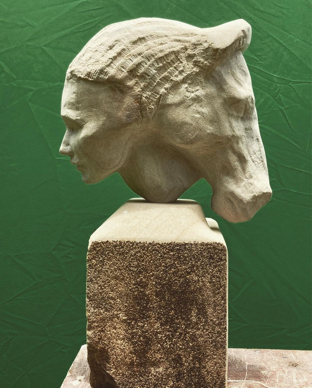 stone sculpture of two-sided bust with woman and horse heads