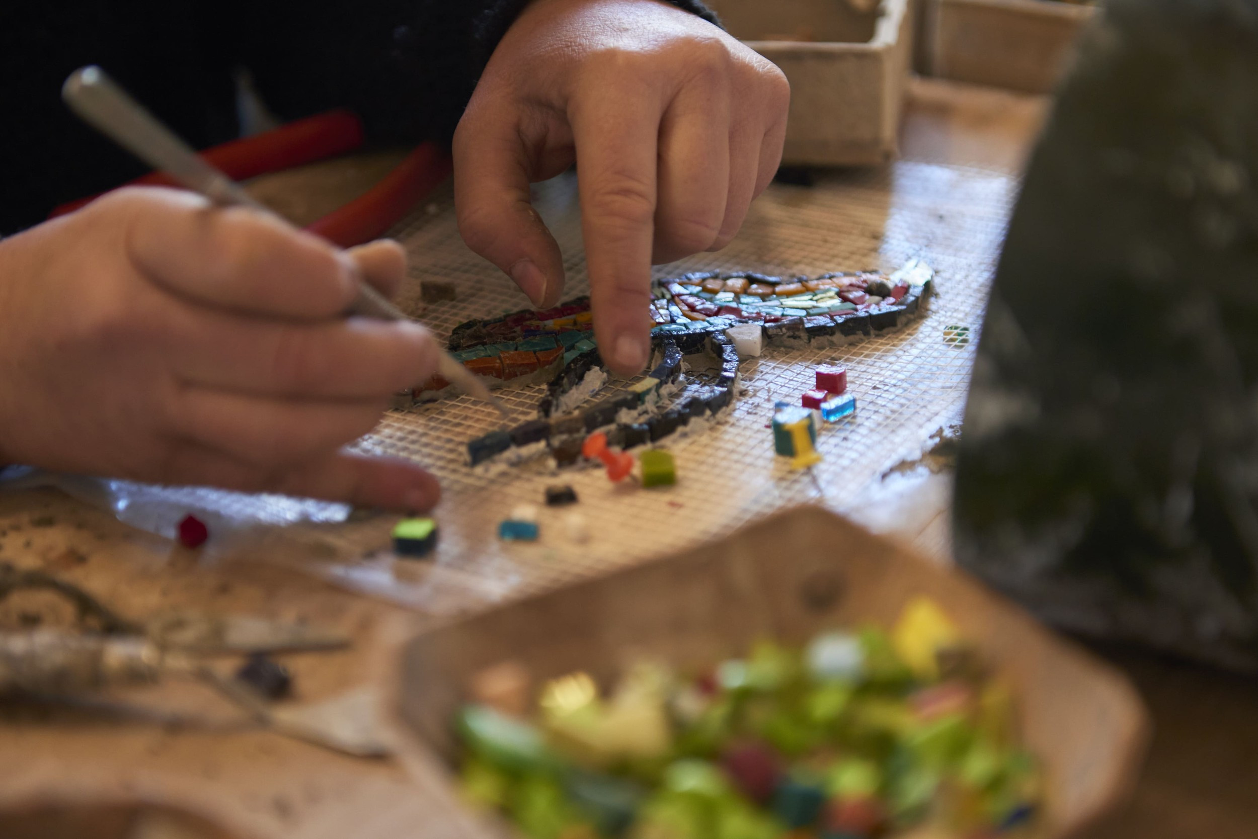 close-up of mosaic artist at work