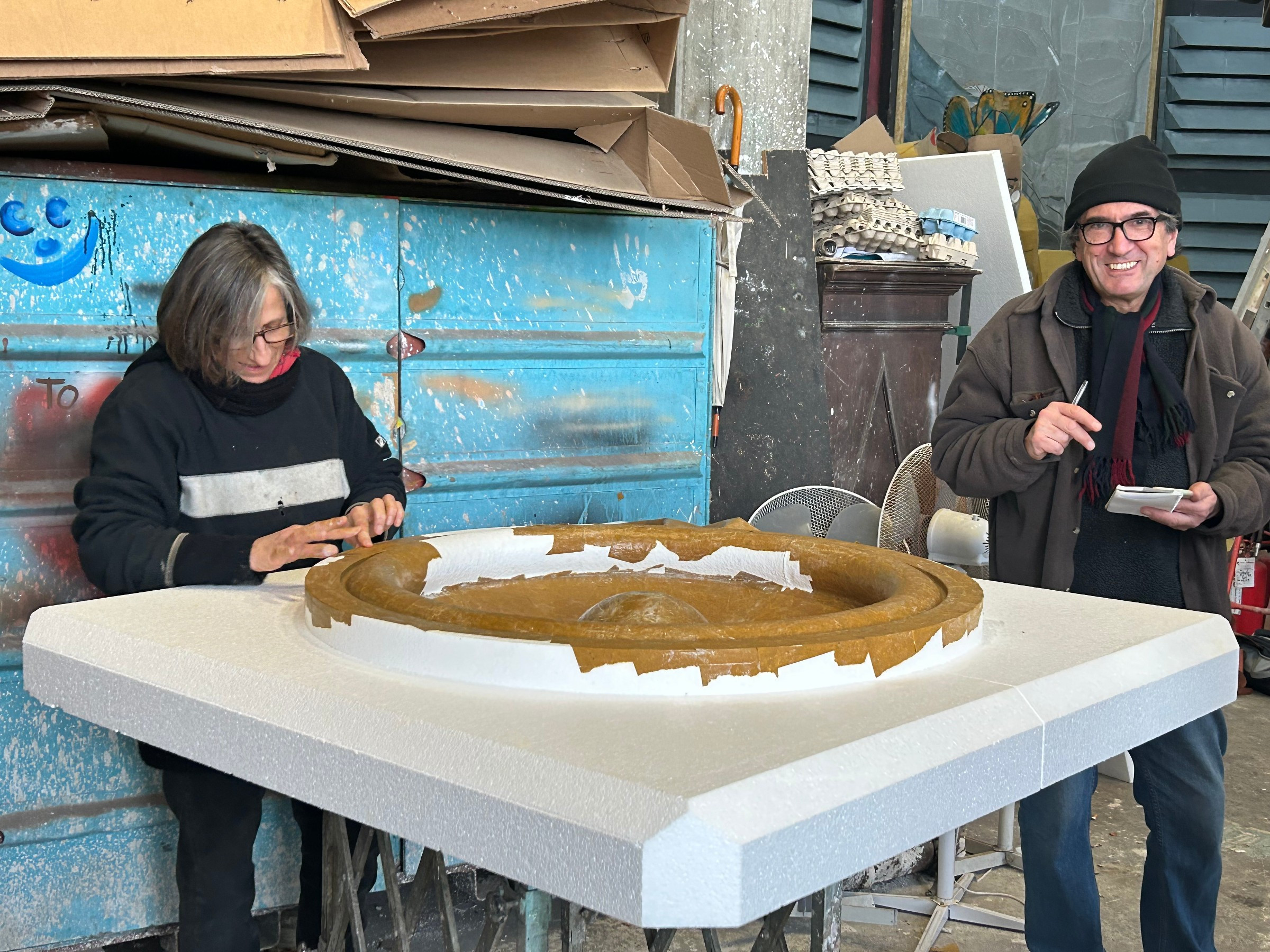 woman and man applying papier-mâché