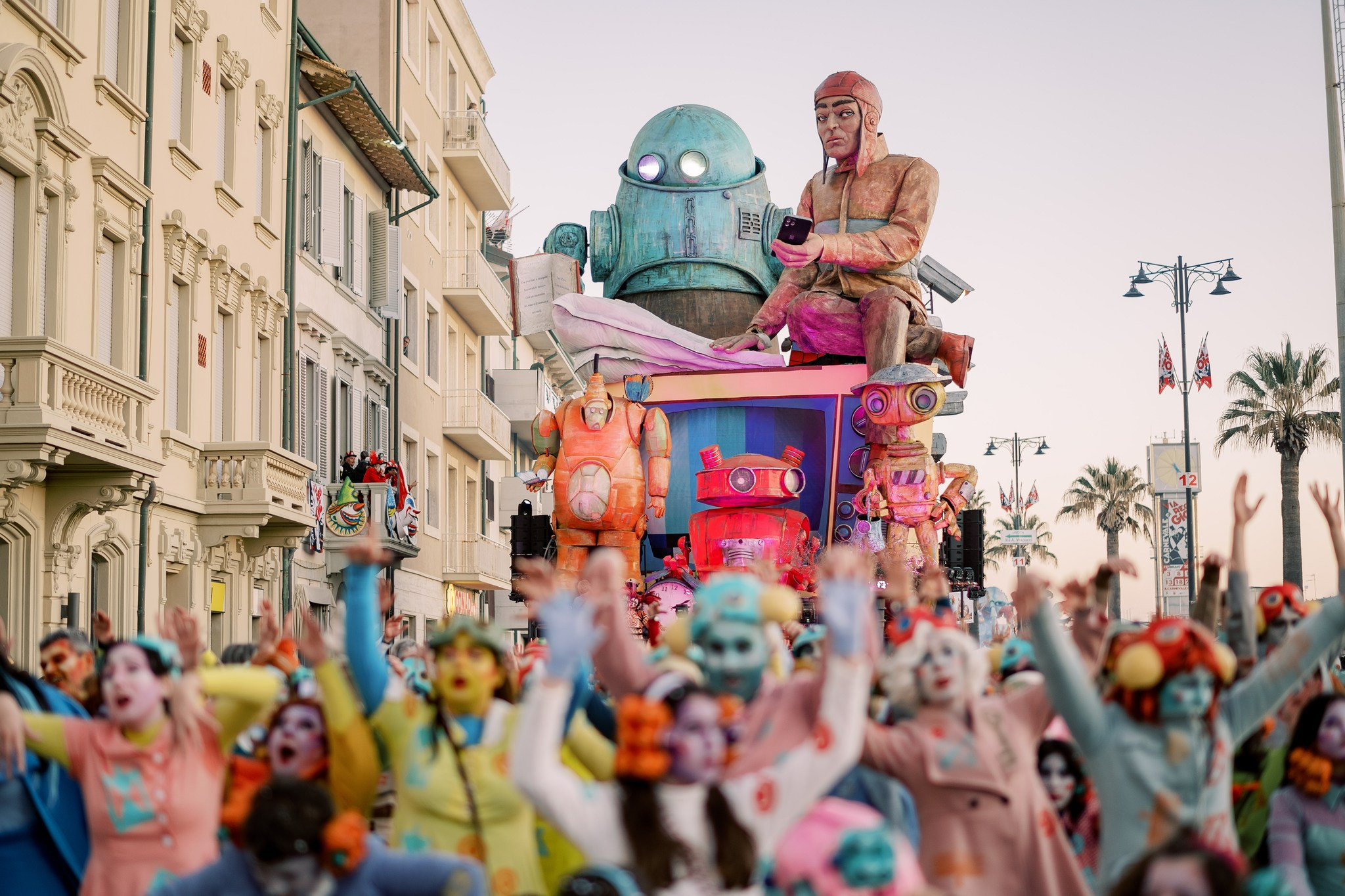 Dancers and a carnival float at dusk