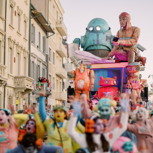 Dancers and a carnival float at dusk
