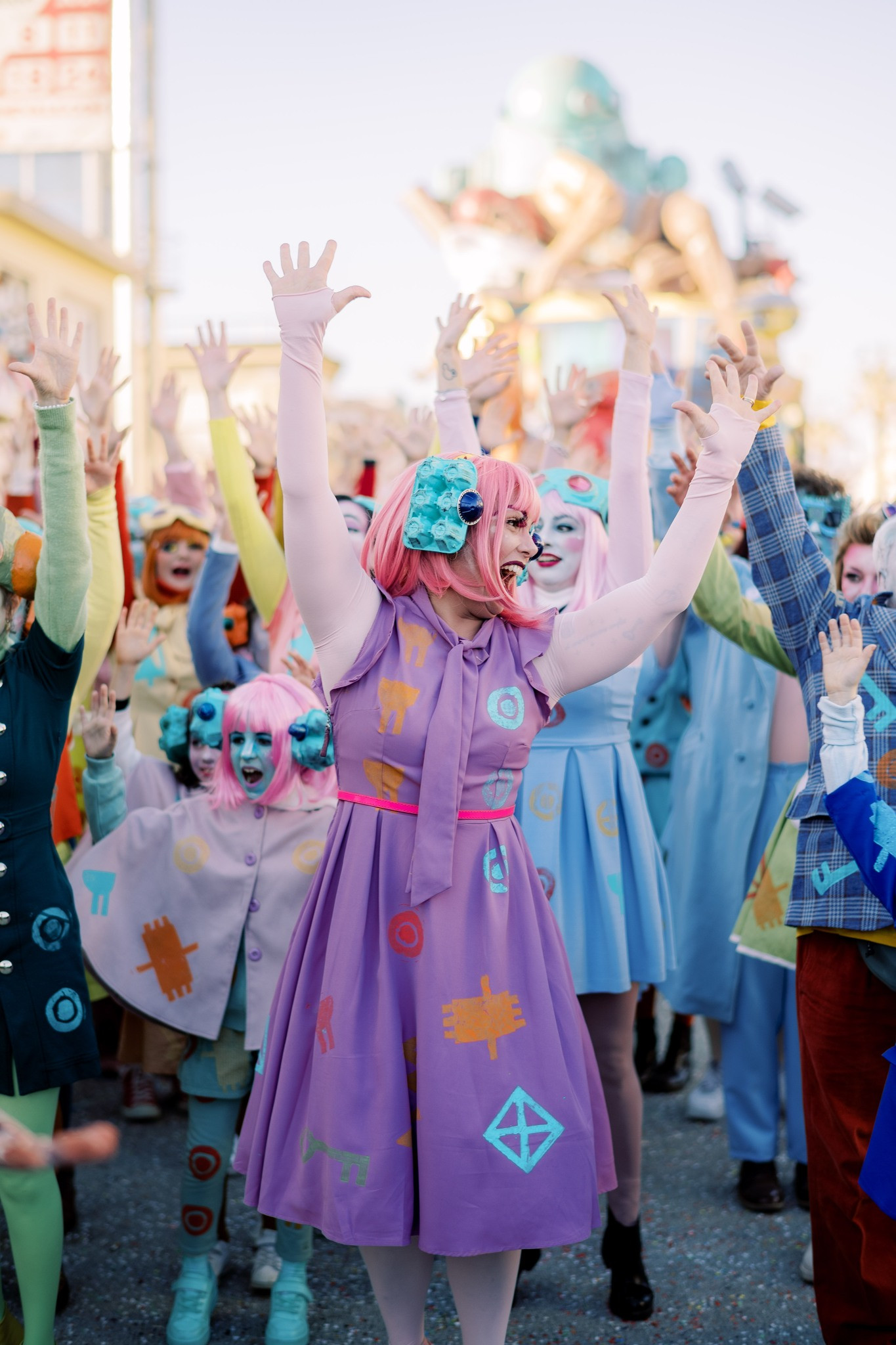 gleeful carnival dancers with arms raised