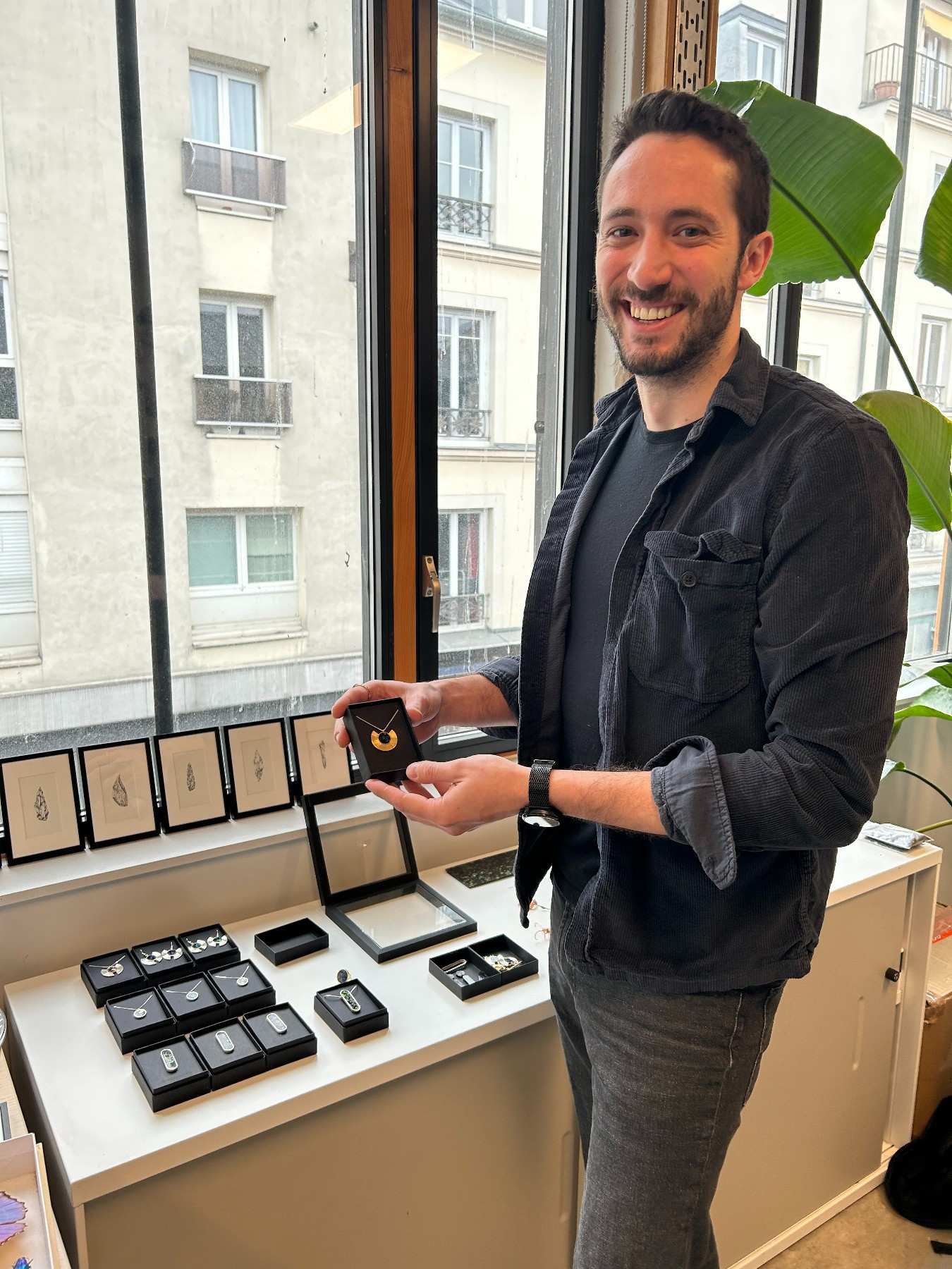 smiling man holding jewellery in a box