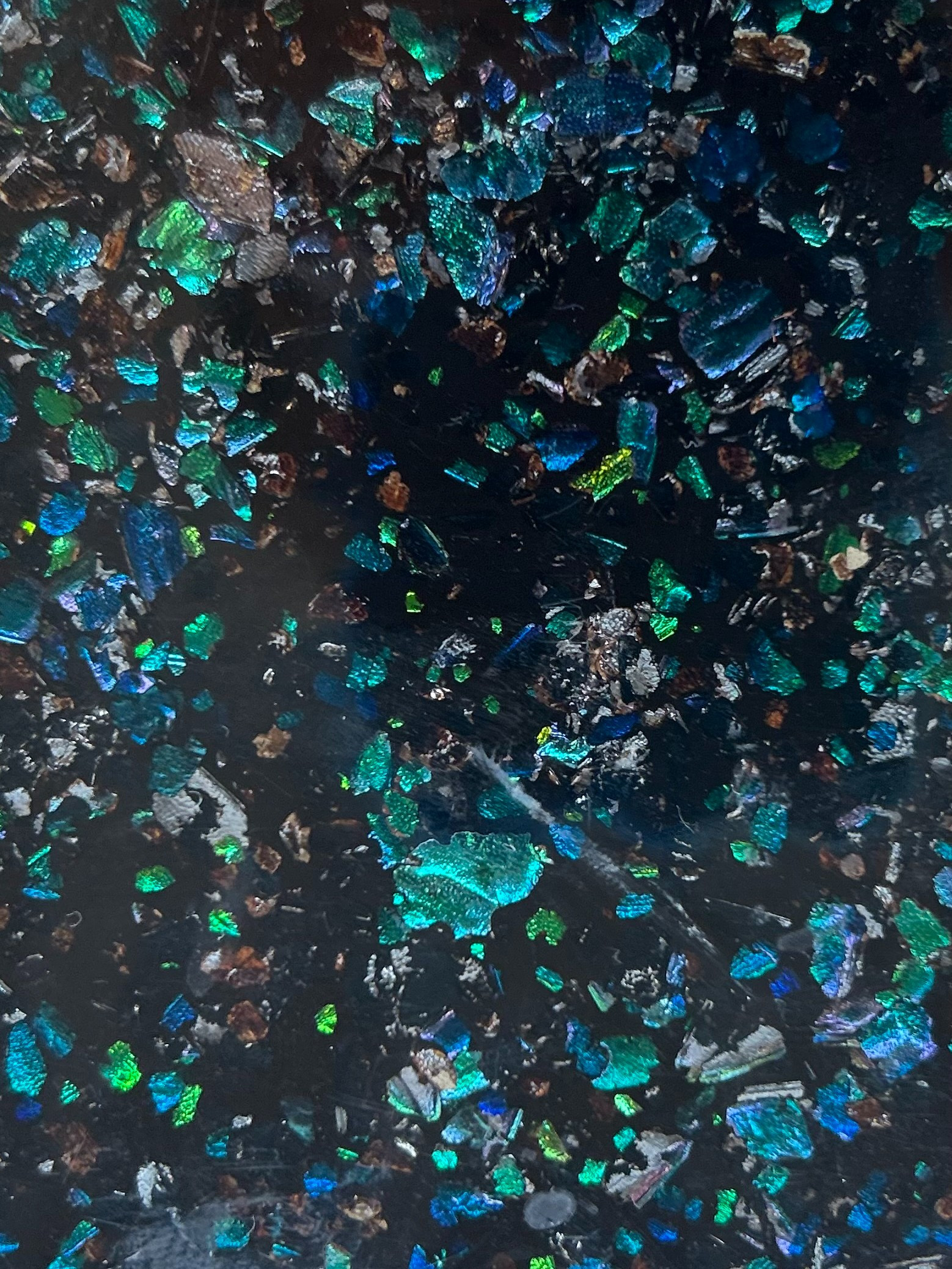 sheet of iridescent material with greens & blues