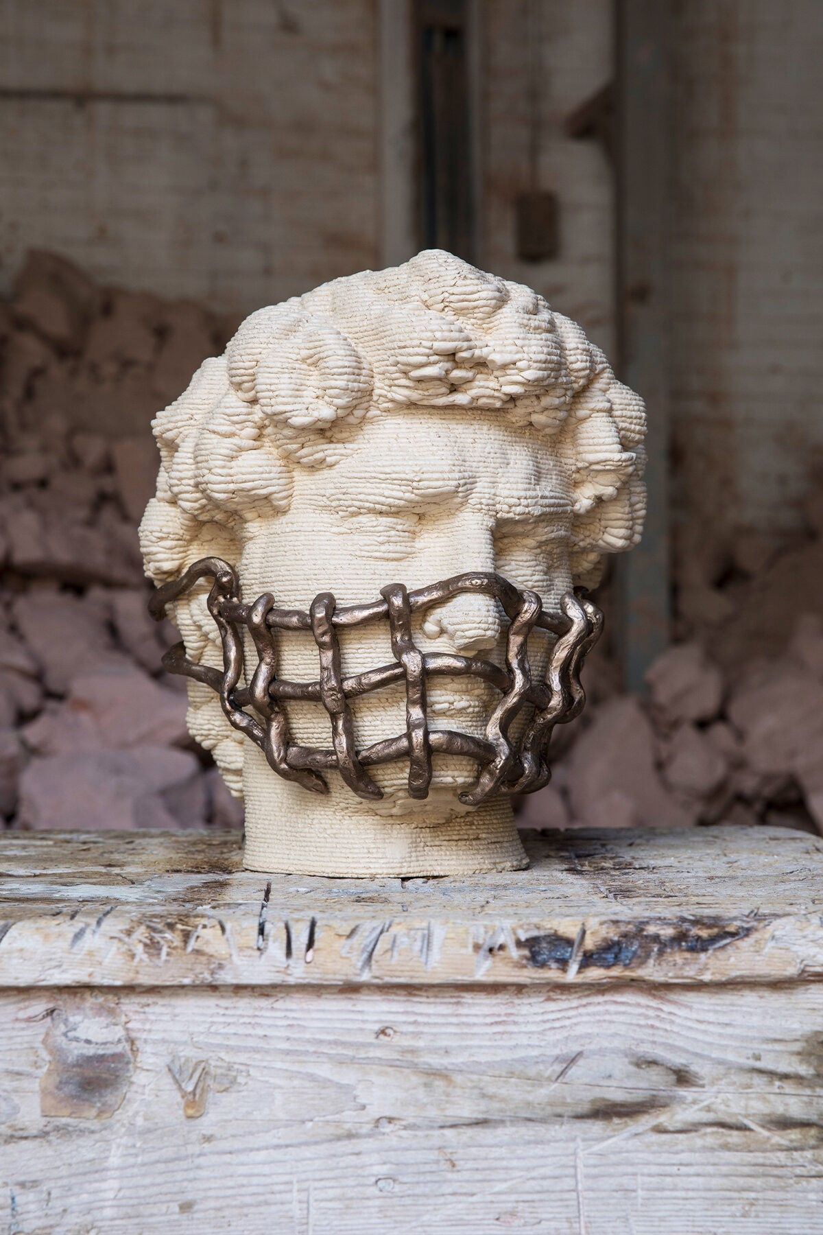 3D print of Michelangelo's David with a facemask made of thick metal wire