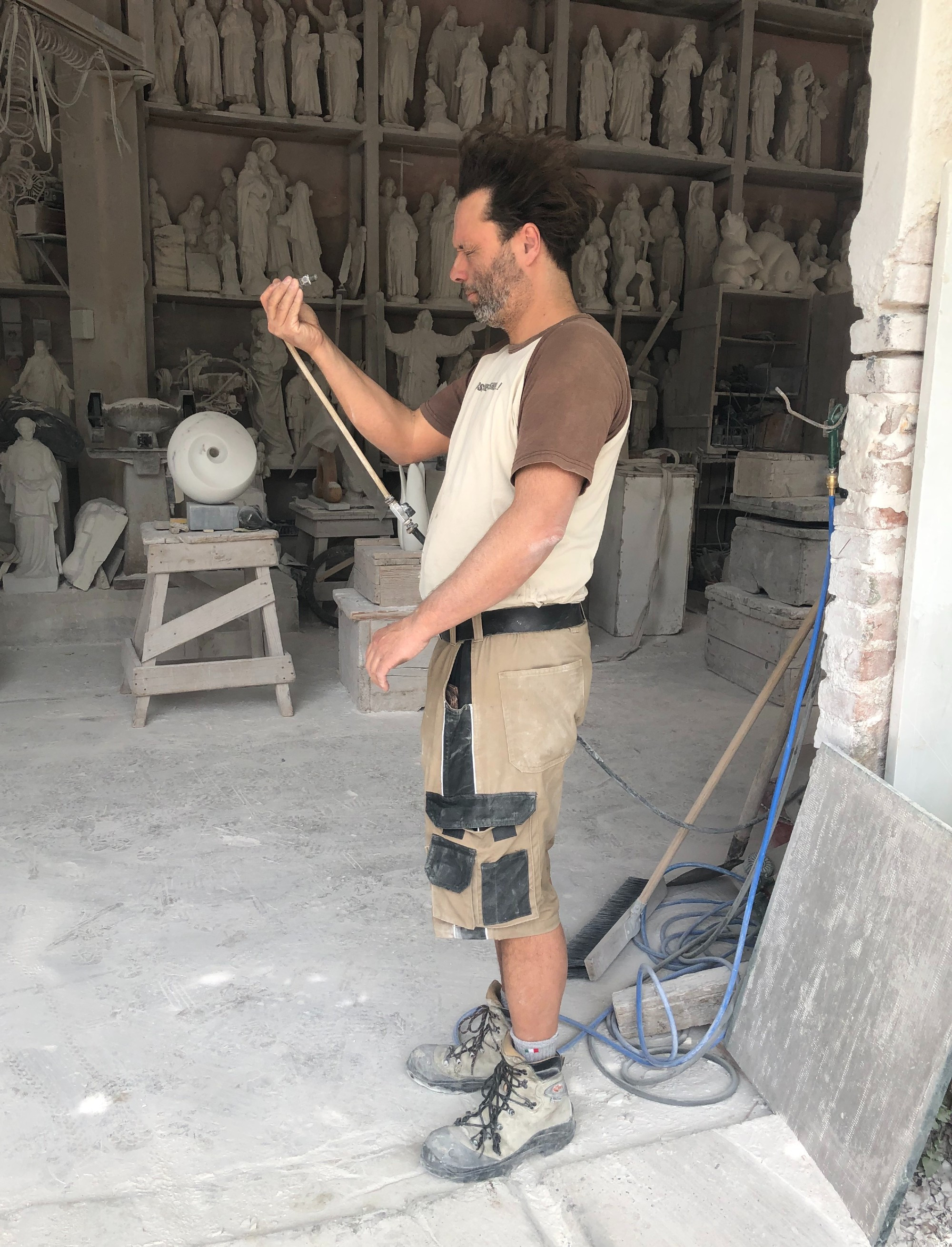 man using air hose to blow off his face