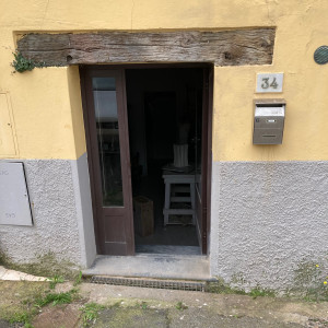 A yellow and grey building entrance way leading into an artist studio.