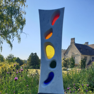 Marble sculpture with coloured glass in a garden