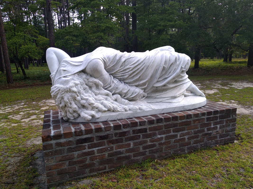 marble outside sculpture of reclining figure