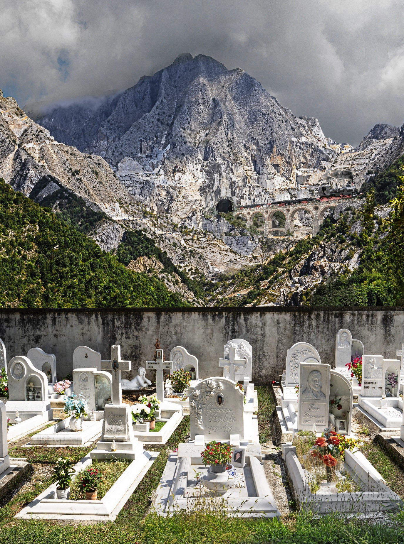 dramatic view of a rocky mountain across a cemetery