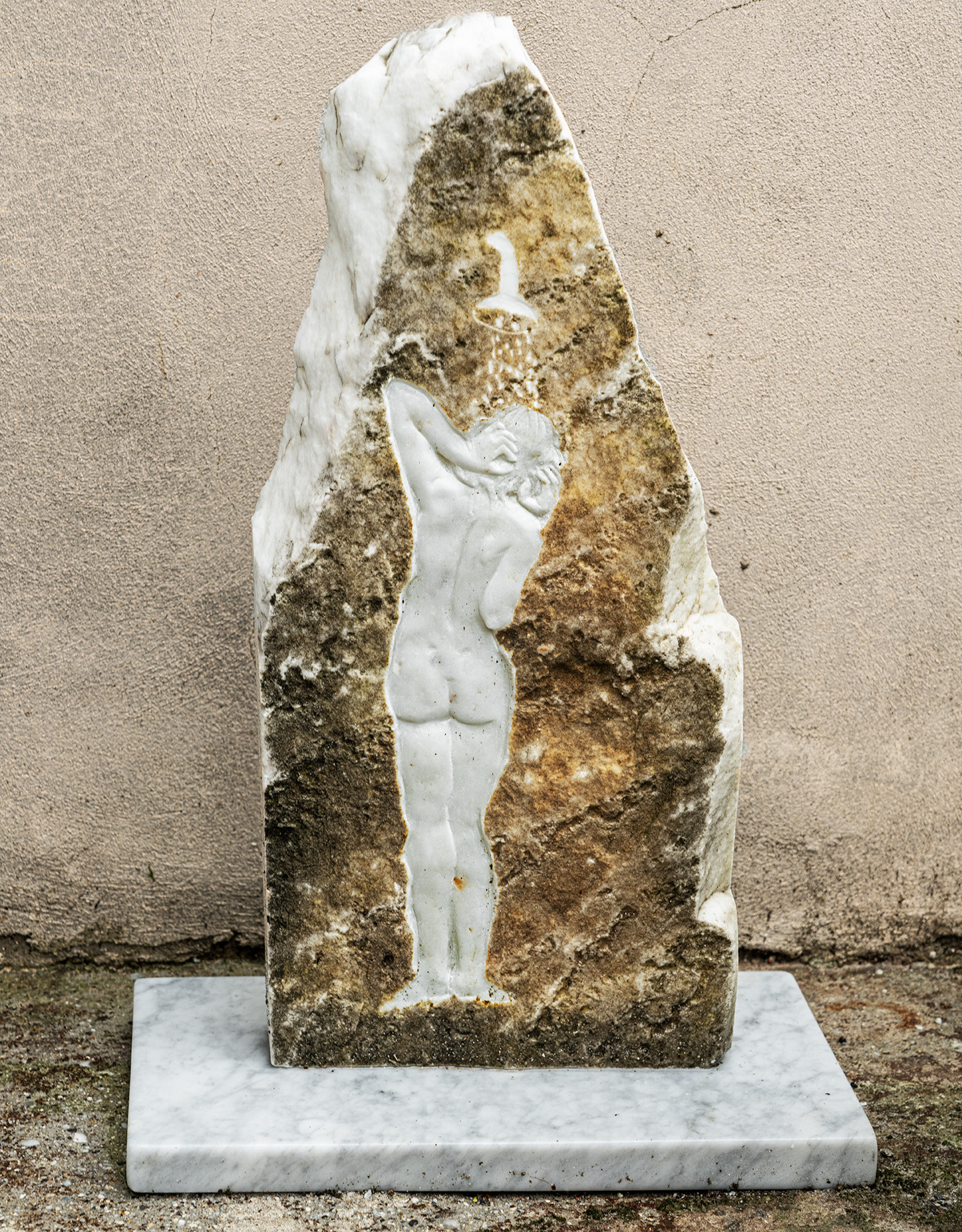 marble relief sculpture of woman beneath shower head