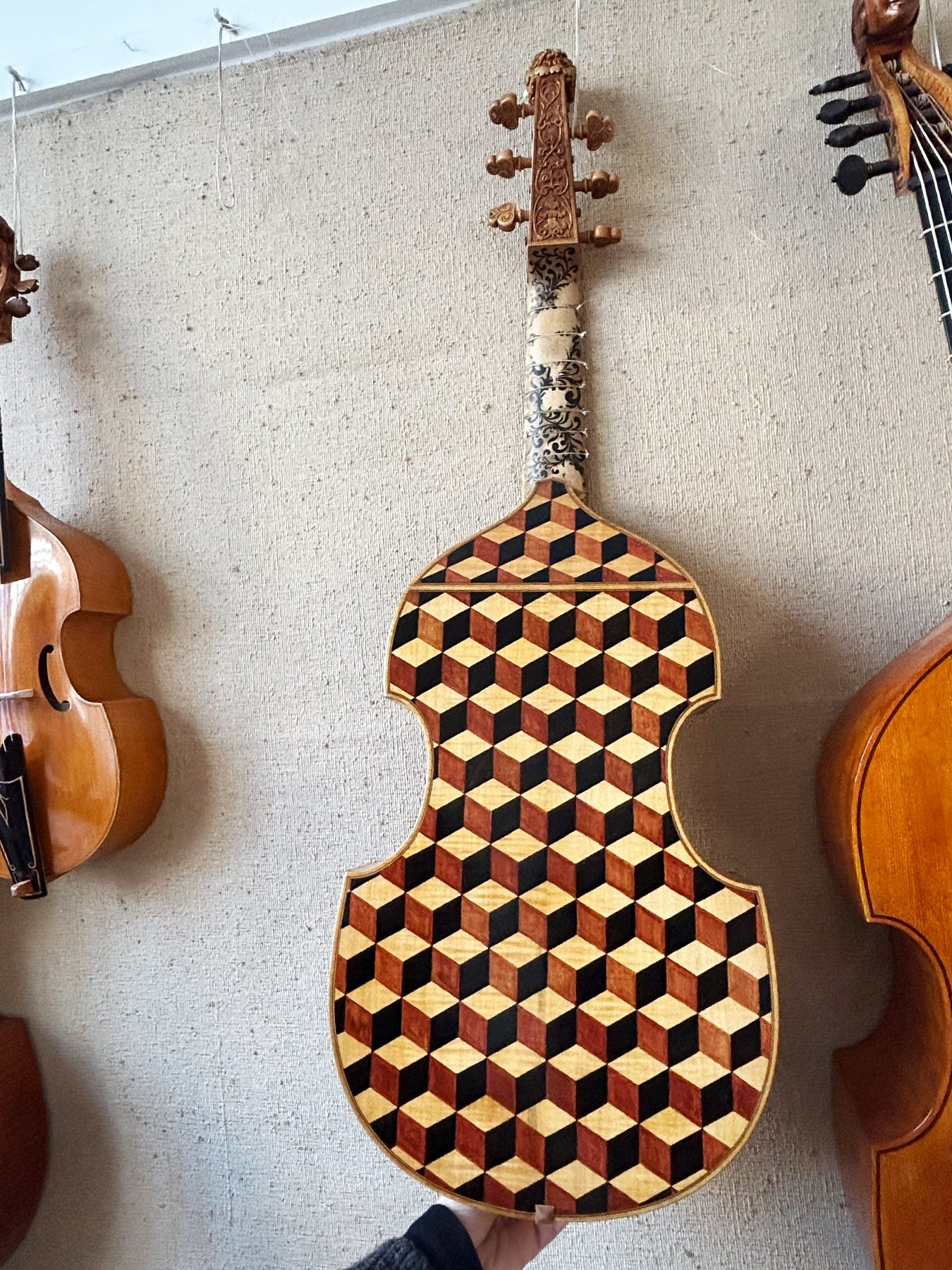 back of stringed instrument with intricate 3D checkerboard marquetry