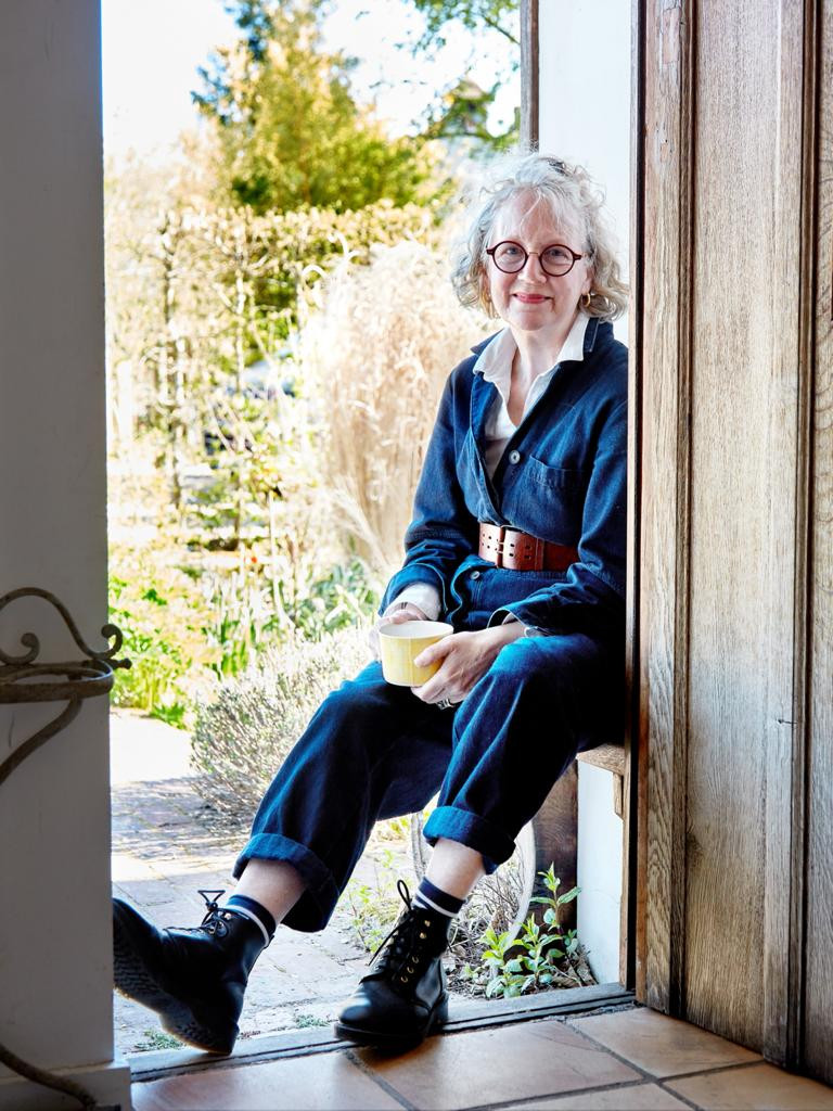 woman sat in sunny doorway
