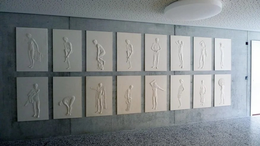 Sixteen bas relief artworks of a nude female figure getting dressed