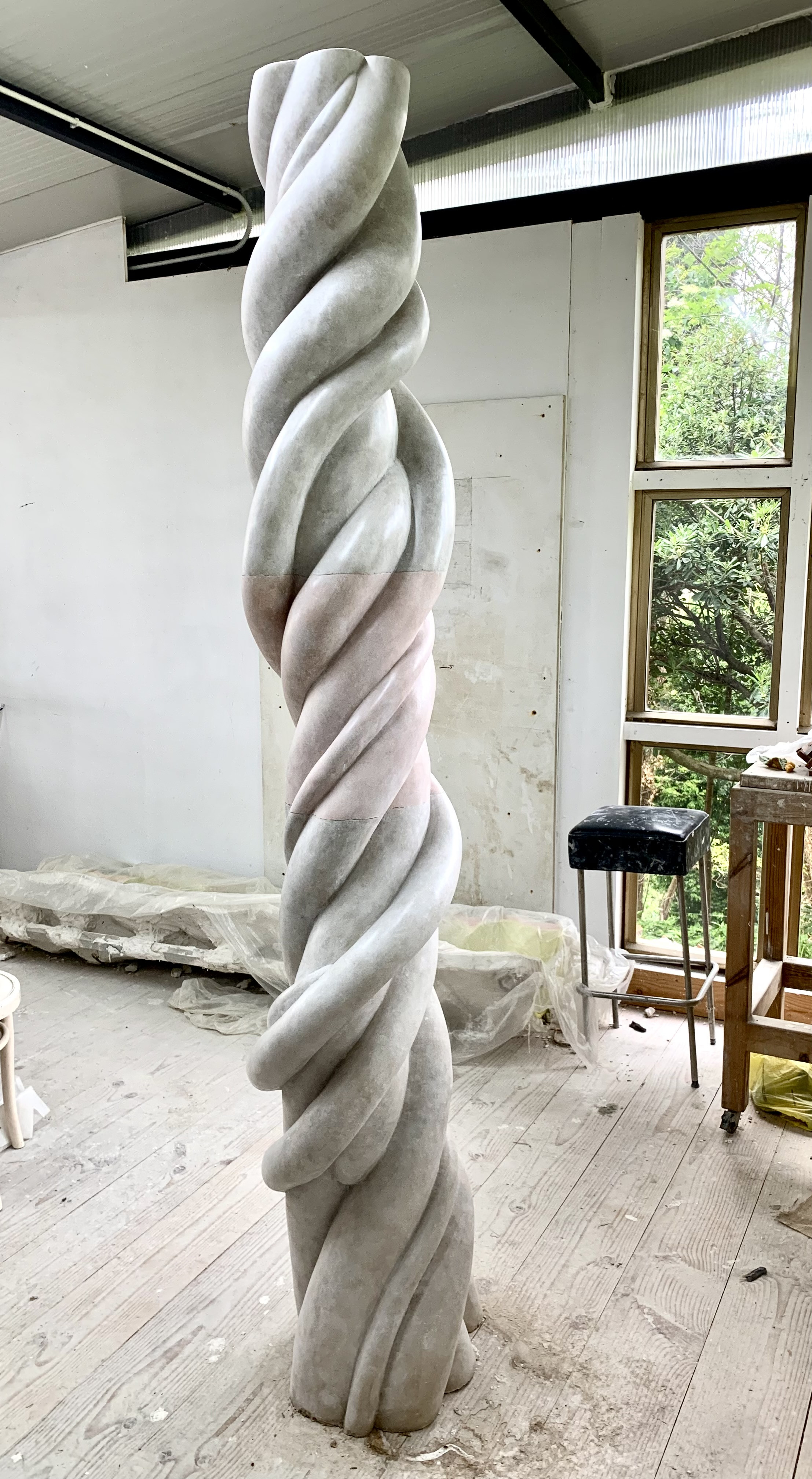 Smooth plaster sculpture of a twisted column