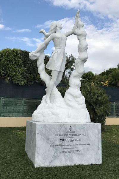white marble sculpture of girl floating in a cloud like structure on a marble plinth