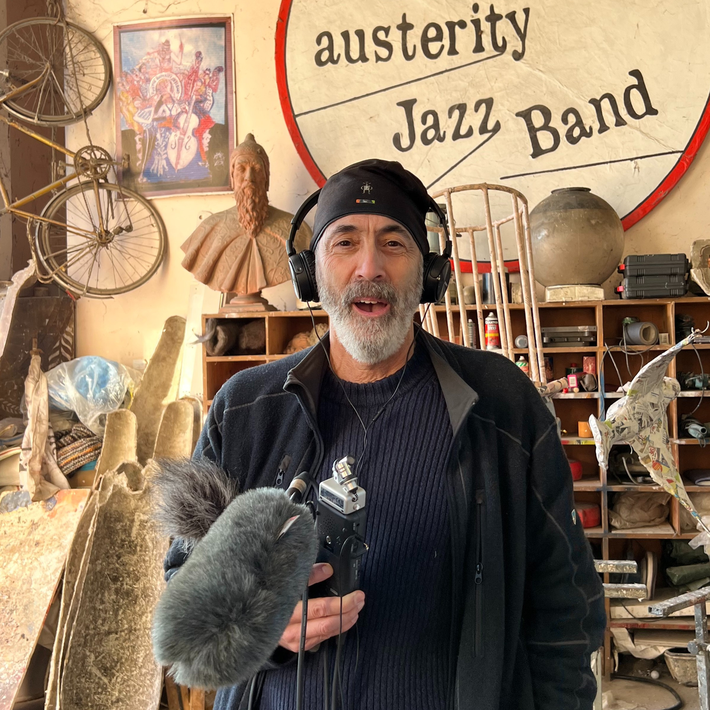 man wearing headphones and holding fuzzy microphone