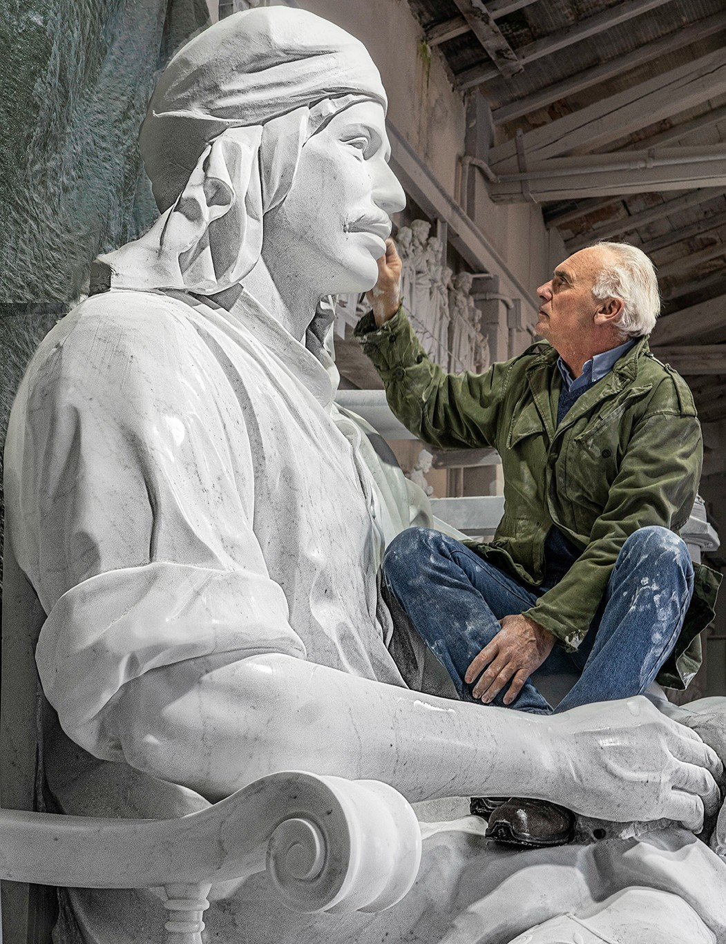 sculptor with oversized marble piece of art