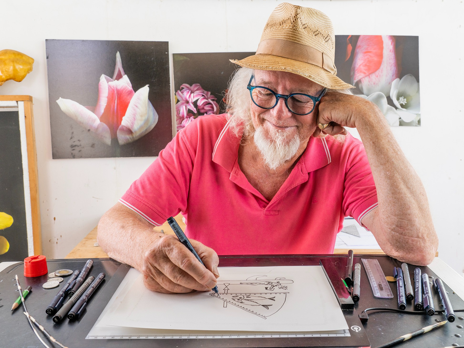 smiling man sketching a drawing