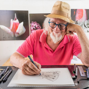 smiling man sketching a drawing