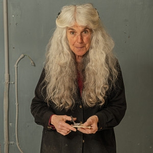 Female collage artist standing at work table