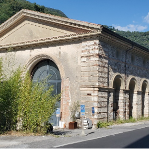 Large brick building with arches on the road.